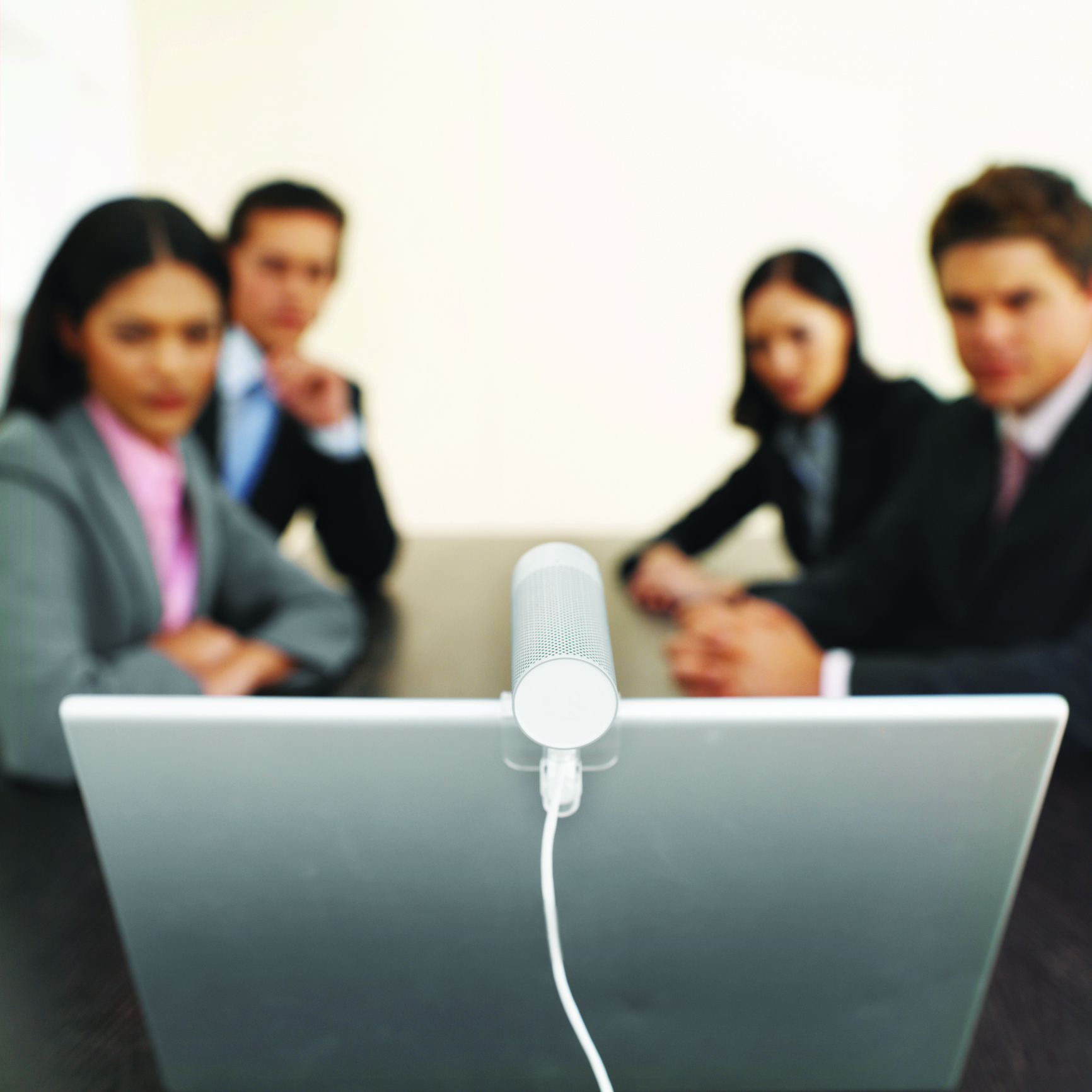 Close-up of four business executives having video conference