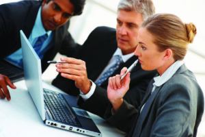 Team of business people working together on a laptop